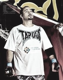 Master Rami Al Banna in a TapouT branded fight shirt, portrait pose.